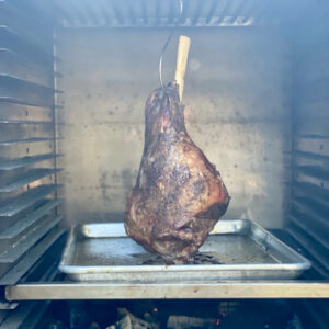 Leg of lamb hanging to smoke and roast